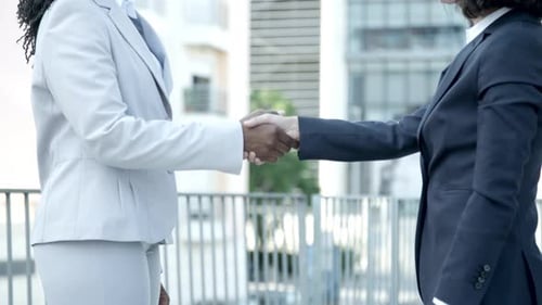 Business Women Shaking Hands On Balcony