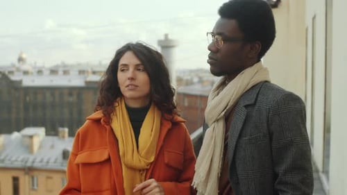 Multiethnic Man and Woman Speaking on Rooftop Terrace