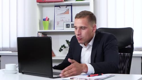 Man in Suit Engaged in Video Conference Call