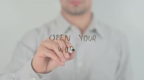 Man Writes Open Your World on Transparent Surface