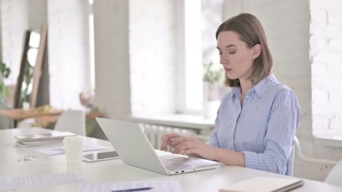 Sick Woman Working on Laptop and Coughing in Modern Office