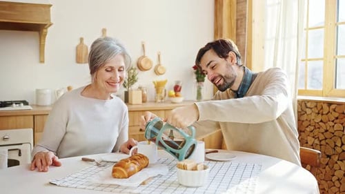 Woman and Man Having Coffee Together at Home