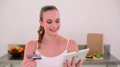 Woman Shops Online with Tablet and Credit Card