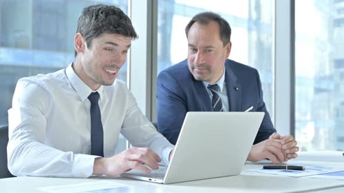 Successful Businessmen Celebrate Achievement at Modern Office