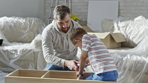 Father and Son Assembling Furniture Together
