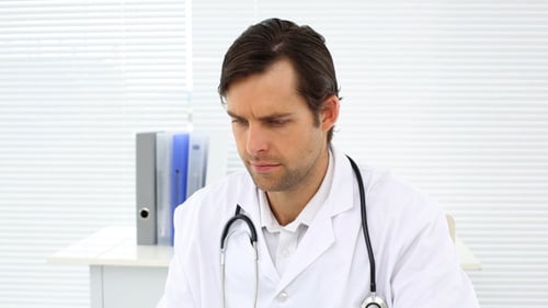 Doctor Checking Xray At His Desk