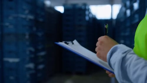Warehouse Worker Making Notes Collecting Information Analysing Shipment Process