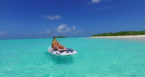 Beautiful beauty models on holiday spending quality time at the beach on paradise white sand and blue