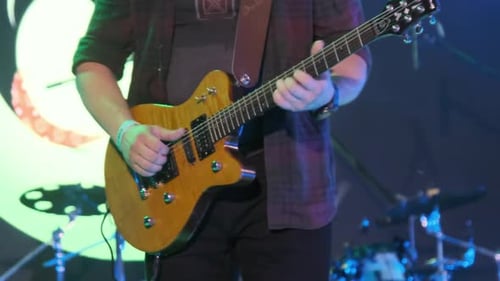 Guitarist at a Rock Concert Plays Electric Guitar on the Open Stage. Slow Motion