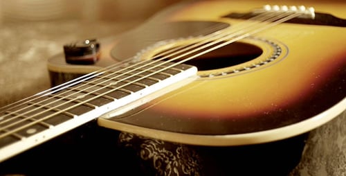 Close Up of Acoustic Guitar on Patterned Surface