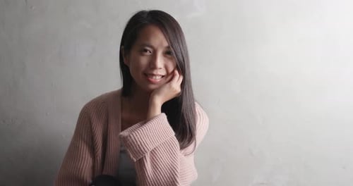 Smiling Young Woman in Simple Portrait Setting