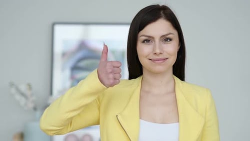 Woman Giving Thumbs Up Gesture Indoors