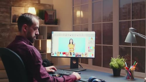 Man Photo Editing at Computer Workstation