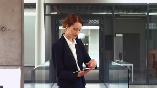 Young Woman Uses Tablet in Bright Office