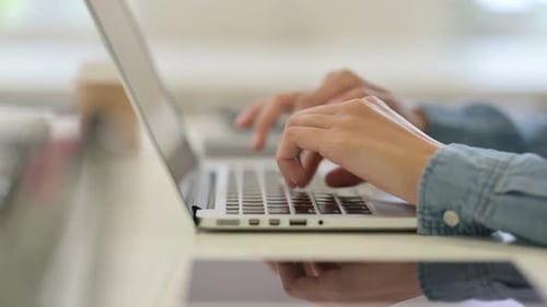 Close Up of Hand of African Woman Typing on Laptop