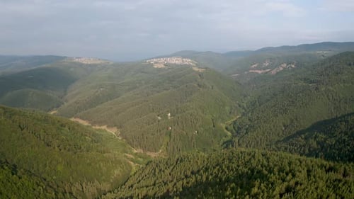 Drone flight over green mountain slopes