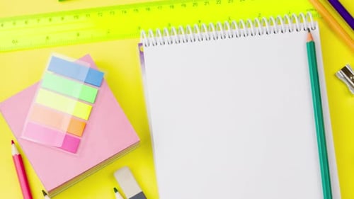 School Supplies Displayed on a Yellow Background