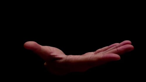 Hand Opens Slowly on Black Background