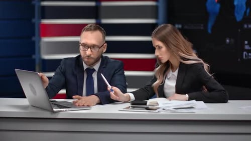 Trendy Male and Female Entrepreneur Talking Pointing on Laptop Screen at Business Meeting in Office