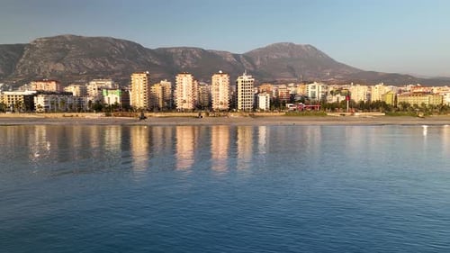 Reflection of the city in the sea aerial view 4 K