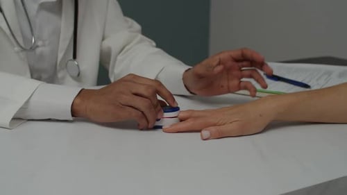 Doctor Checking Patient's Oxygen Levels With Oximeter