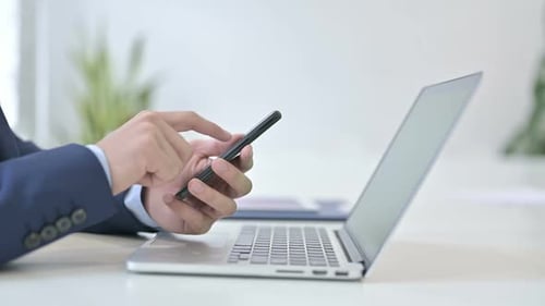 Side View of Businessman Using Smartphone
