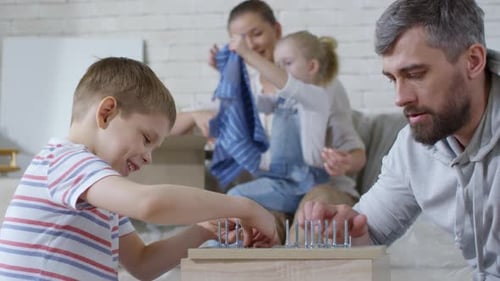 Happy Boy and Man Arranging Screws