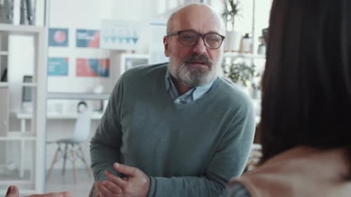 Man Explaining Business Strategy in Office Setting