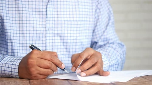 Man Hand in Fountain Pen Writing or Signature on Paper