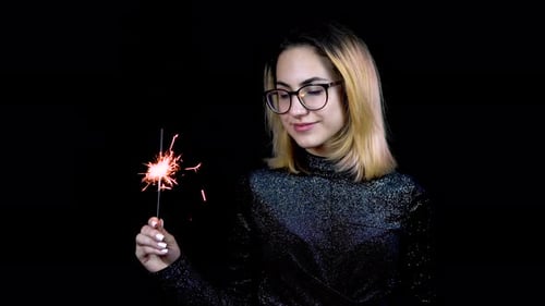 Woman Holding Sparkler in the Dark