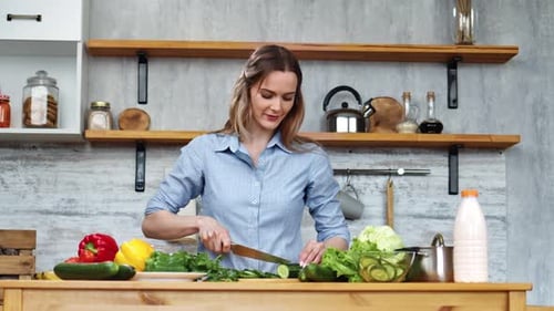 Woman Chopping Fresh Vegetables in Bright Kitchen