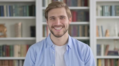 Smiling Man with Beard and Bookshelves