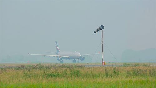 Passenger Airplane on Runway in Overcast Weather