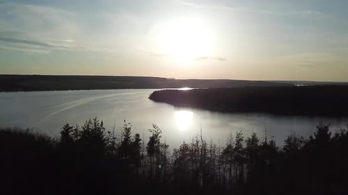Aerial View. Flying over the beautiful autumn River. Beautiful sunset over lake