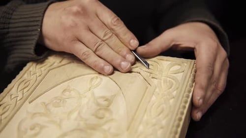 Hands of Craftsman Carving Wooden Design