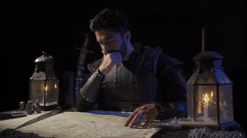 Man Studies Map by Candlelight in Dark Setting