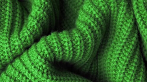 The Texture of the Fabric. Green Knitted Texture. Close-up. Can Be Used As a Background.