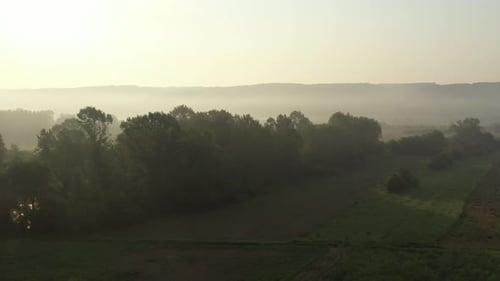 Aerial View of Foggy Rural Landscape at Sunrise
