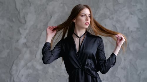 Stylish Woman Posing in a Black Dress