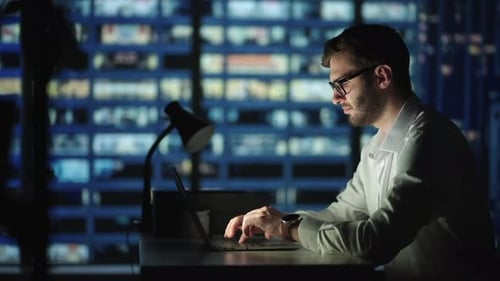 Portrait of Thoughtful Successful Businessman Working on Laptop Computer in His Big City Office at
