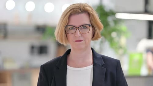 Portrait of Serious Old Businesswoman Looking at Camera