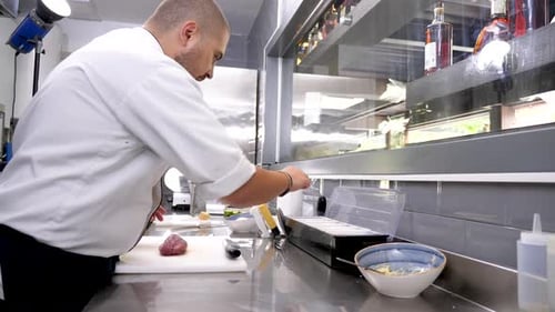 Cook at the Kitchen Preparing Beef Meat for Grill