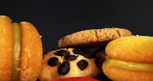 Colorful Cookies Piled High on Black Background