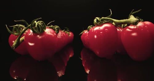 Close Up Fresh Red Tomatoes on Black Reflective Surface