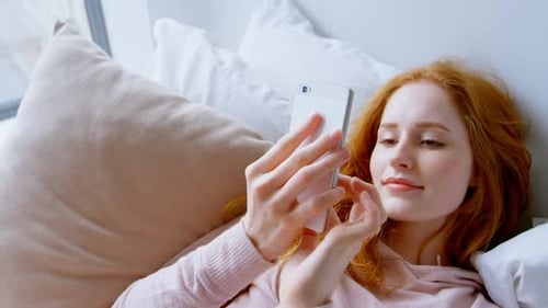 Woman using mobile phone in bedroom 4k