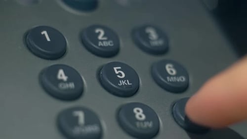 Fingers Dialing a Landline Telephone Keypad