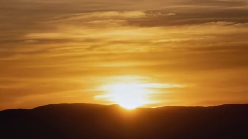 Golden Sunrise over Silhouetted Mountains