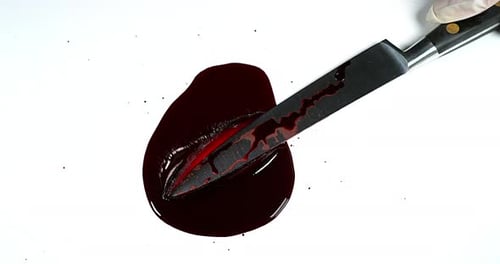 Knife with Blood against White Background, Slow Motion
