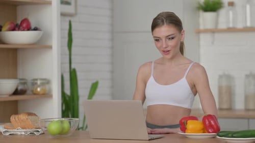 Woman Video Chatting on Laptop with Vegetables