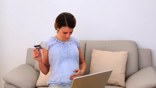 Young Adult Woman using Laptop and Credit Card